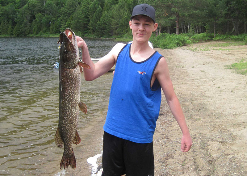 This is a photo of a boy holding a 10 pound Northern Pike